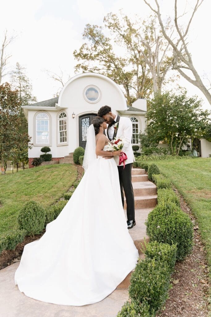 Bride and groom kissing outside Morais Vineyards after wedding ceremony