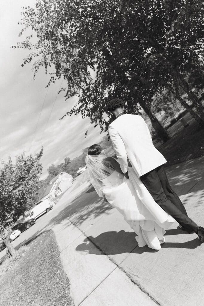 Bride and groom walking together through Morais Vineyards grounds