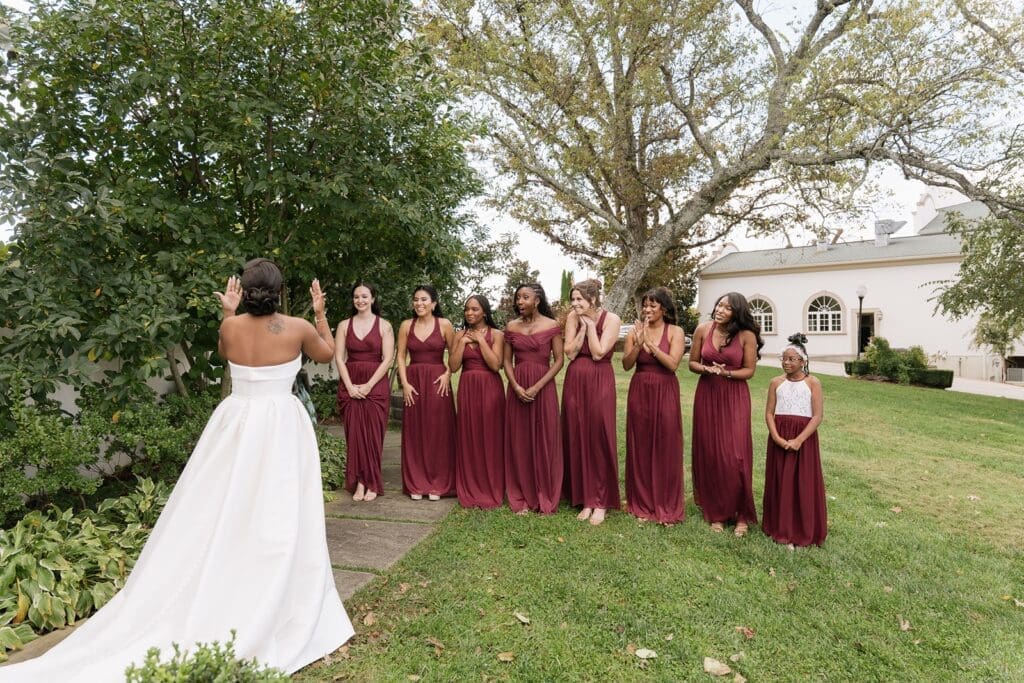 Bridesmaids reacting during emotional first look at Morais Vineyards