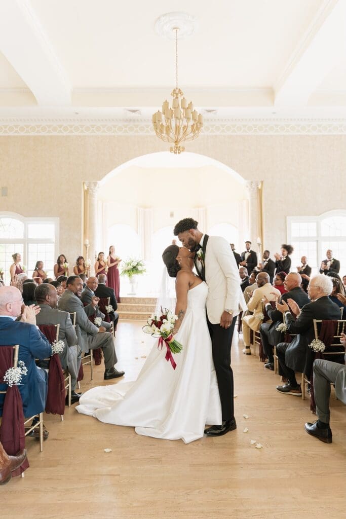Bride and groom kissing during Morais Vineyards wedding ceremony