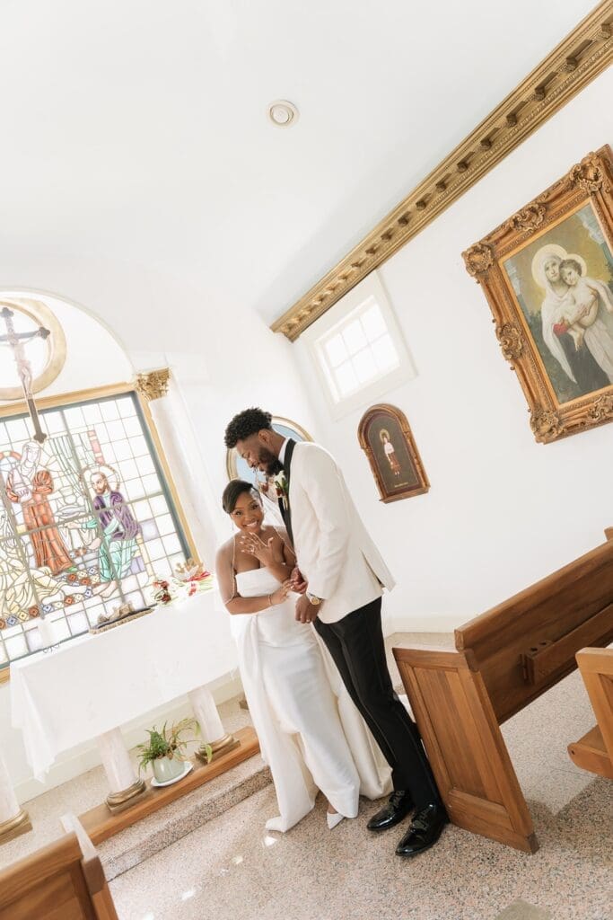 Bride and groom embracing inside Morais Vineyards chapel