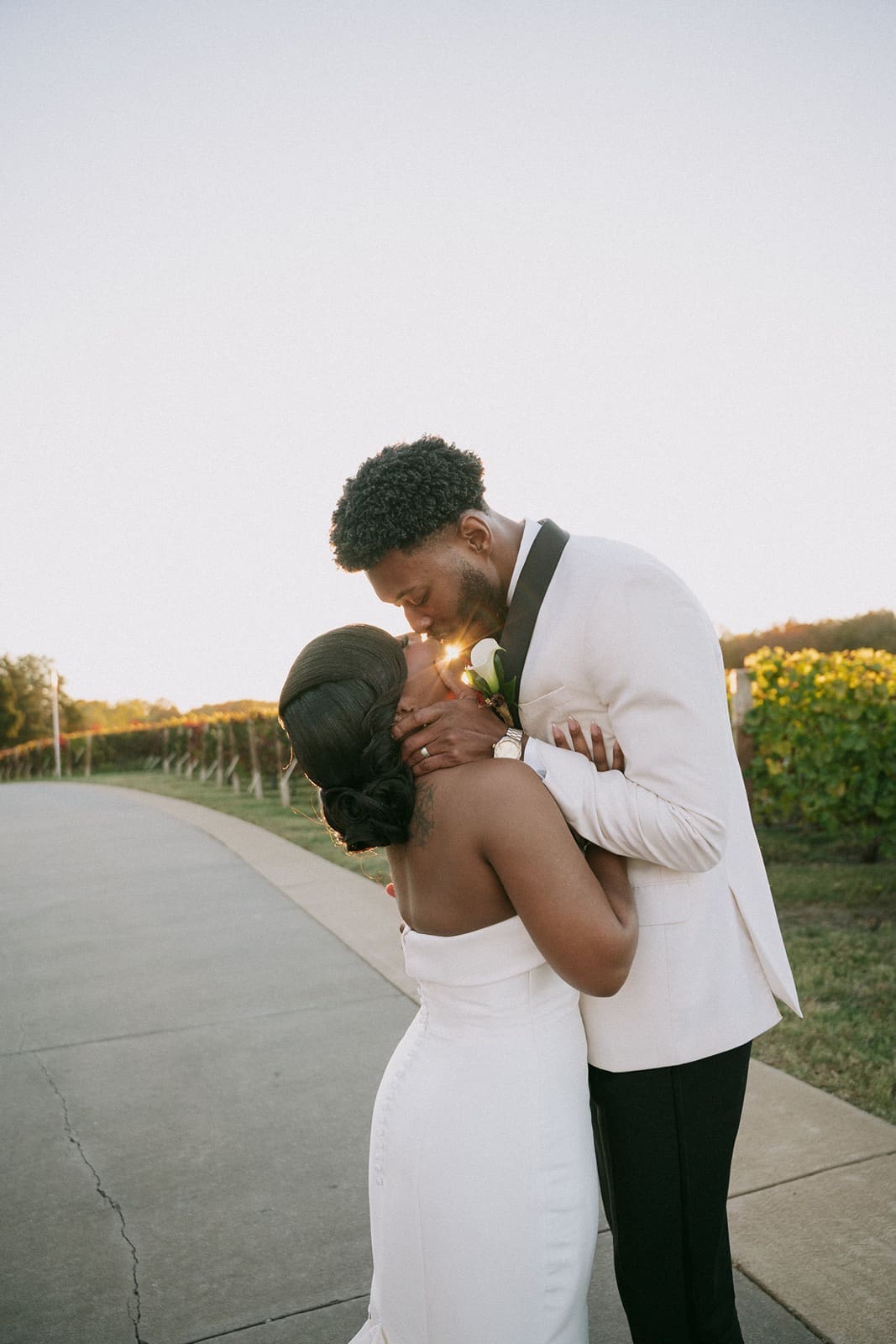 Bride and groom kissing during sunset at Morais Vineyard and Winery.