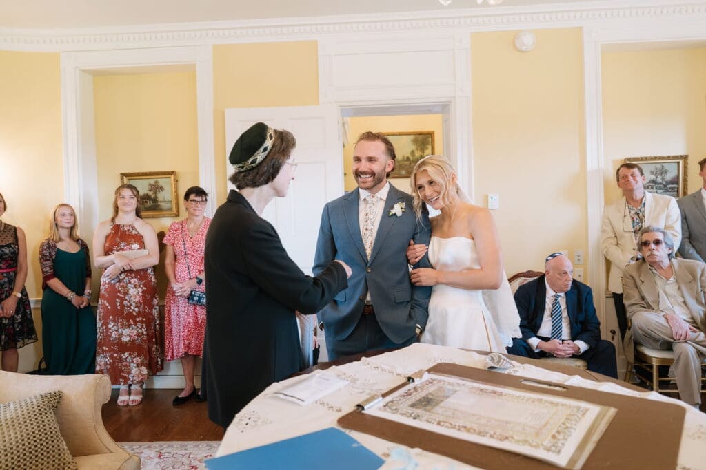 Jewish wedding traditions with couple and rabbi at Belmont Manor