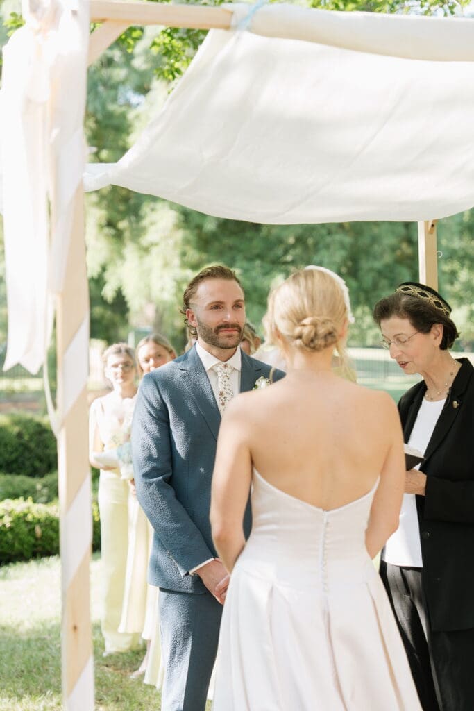 Groom during a Jewish wedding ceremony under the chuppah at Belmont Manor Historic Park
