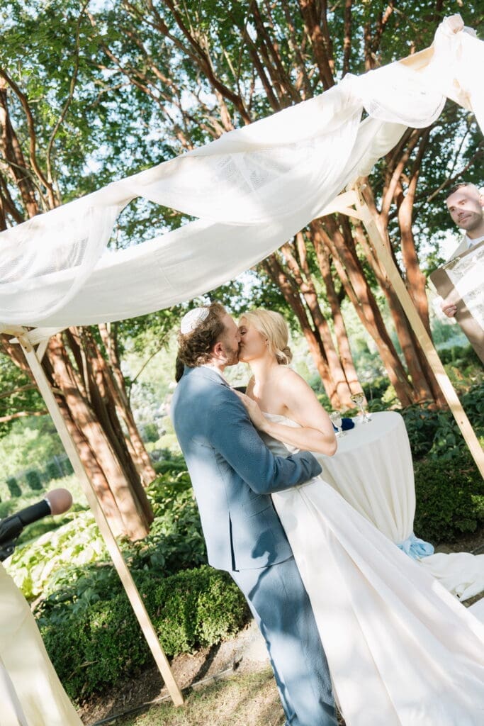 Jewish wedding ceremony kiss under the chuppah