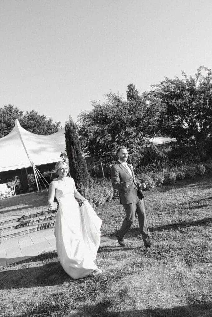 Bride and groom walking through the garden at Belmont Manor MD