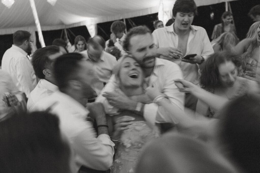 Joyful bride and groom dancing during wedding reception