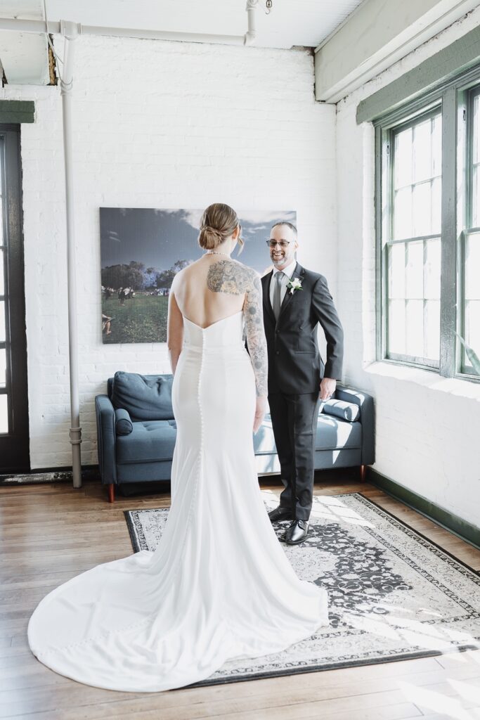 Bride sharing an emotional first look with her father at The Woolen Mill wedding before the ceremony.