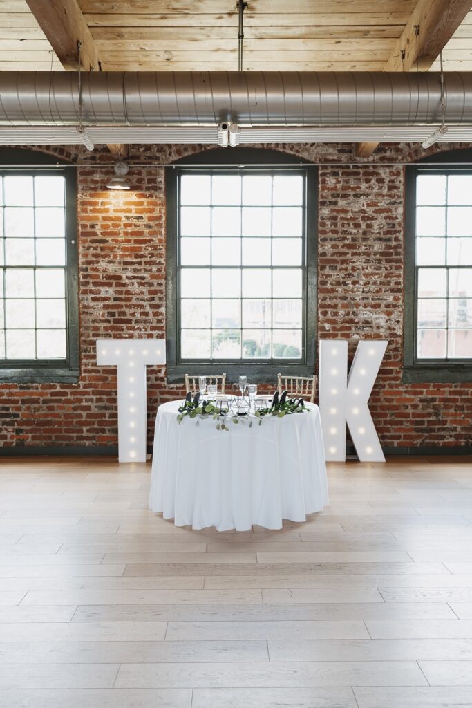 Elegant reception sweetheart table at The Woolen Mill in Fredericksburg, Virginia.