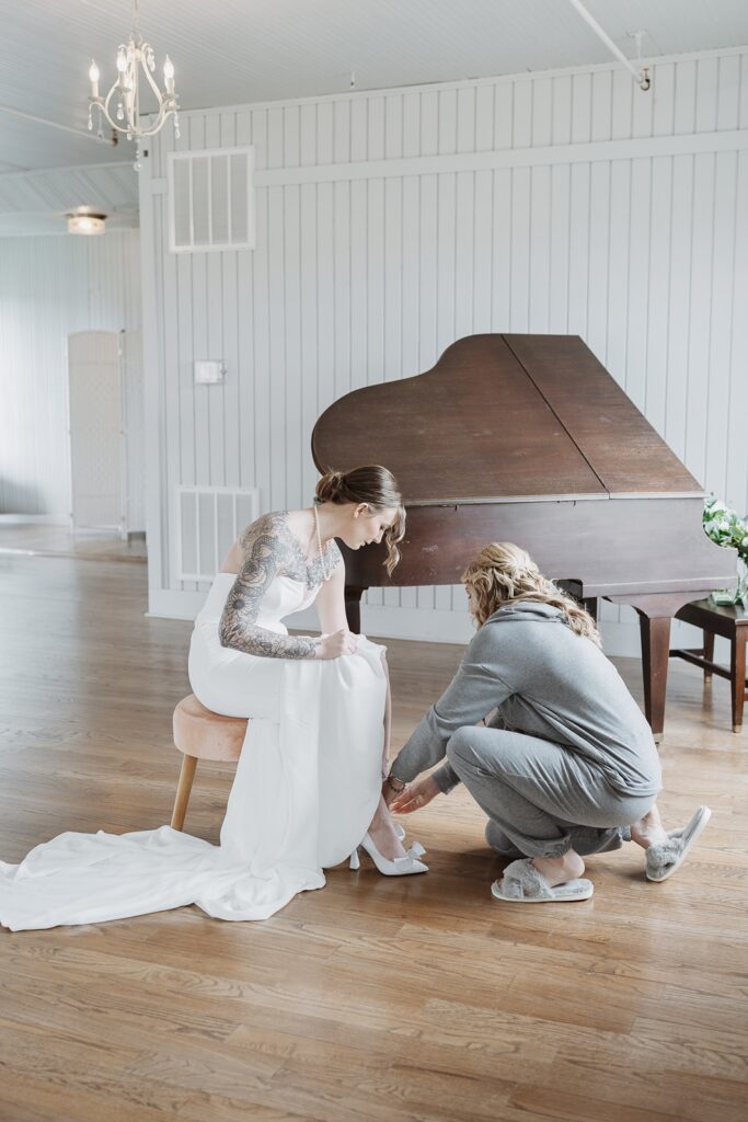 Bride having the finishing touches added before the ceremony.