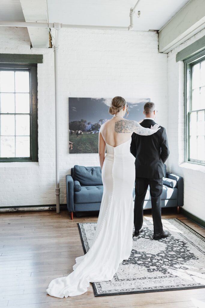 Bride sharing an emotional first look with her father at The Woolen Mill wedding.
