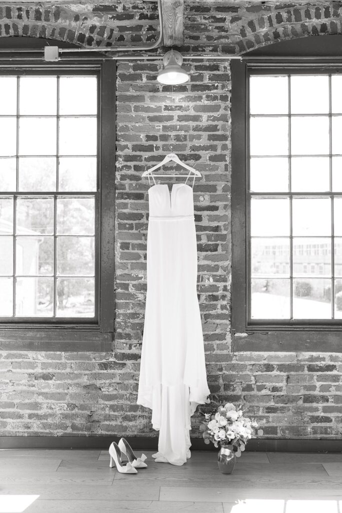 Bride's wedding dress hanging inside The Woolen Mill in Fredericksburg, Virginia.
