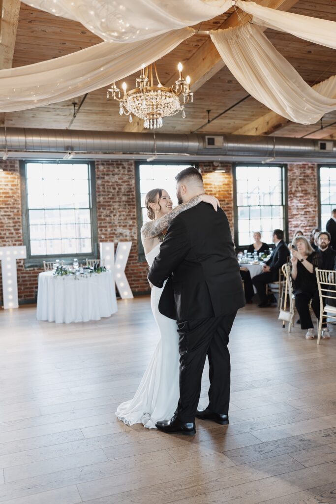 Bride and groom sharing their first dance during their wedding reception.