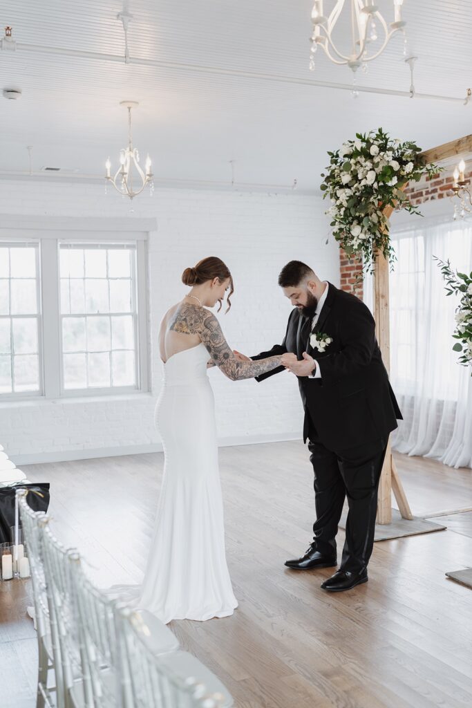 Bride and groom sharing an emotional first look before their wedding ceremony at The Woolen Mill.