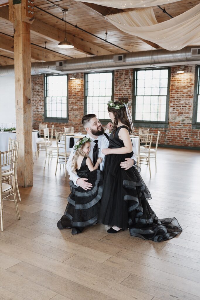 Groom sharing a first look with his daughters before the wedding ceremony.