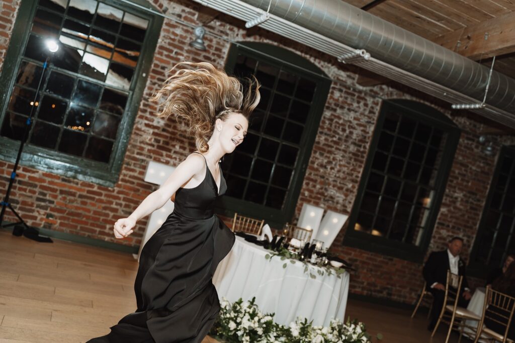 Guests celebrating on the dance floor during The Woolen Mill wedding reception.