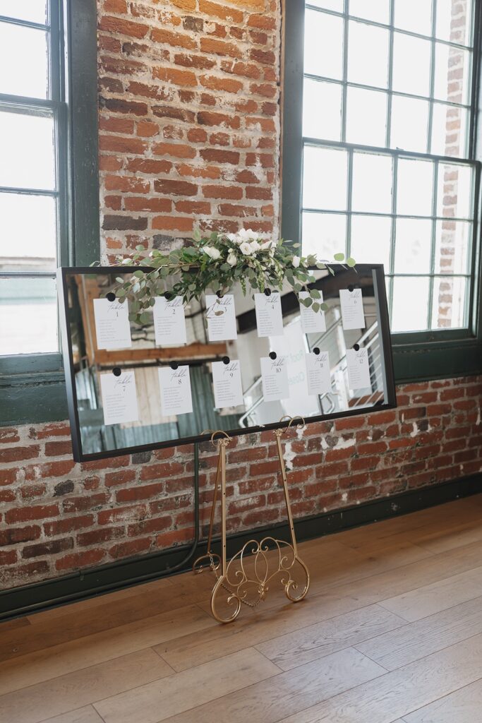 Elegant reception sitting chart decor at The Woolen Mill in Fredericksburg, Virginia.