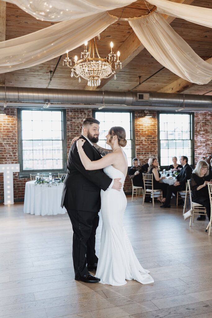 Bride and groom sharing their first dance during their wedding reception at The Woolen Mill.