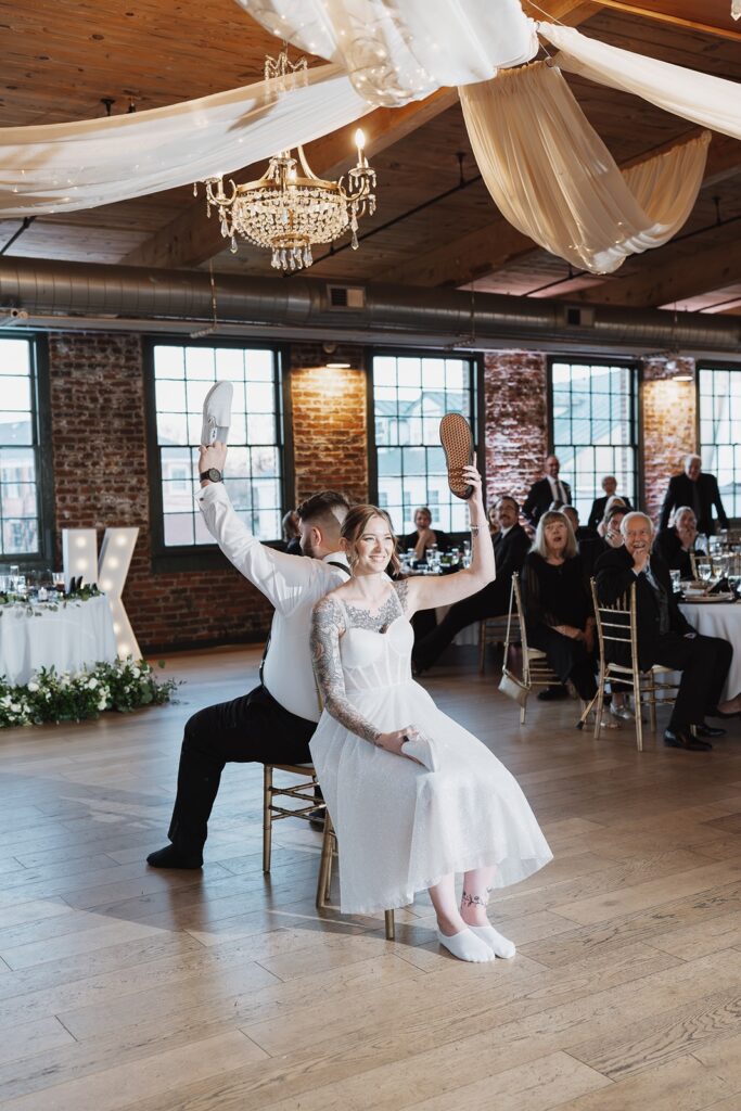 Bride and groom having fun during a wedding reception at The Woolen Mill in Fredericksburg, Virginia.